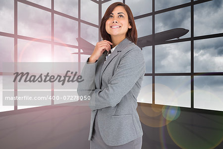 Thoughtful businesswoman against airplane flying past window