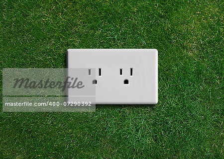 electricity  adapter on a green grassland, Green energy concept, Green power.