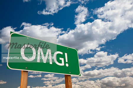 OMG!, Texting Abbreviation for Oh My Gosh, Green Road Sign with Dramatic Sky and Clouds.