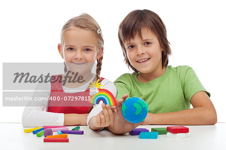 Kids making colorful ecology theme clay figures - holding earth globe and rainbow