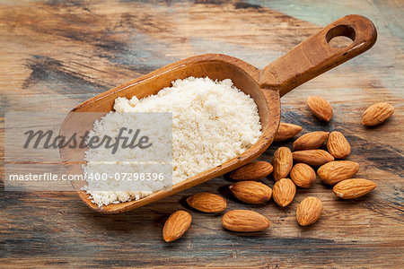 almond flour high in protein, low in carbohydrates, low in sugars and gluten free - a rustic wooden scoop on grained wood background