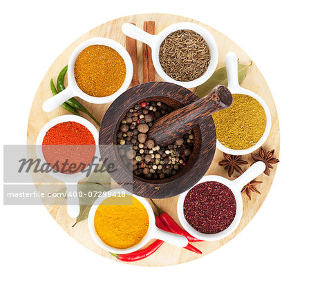 Various spices selection on cutting board. Isolated on white background