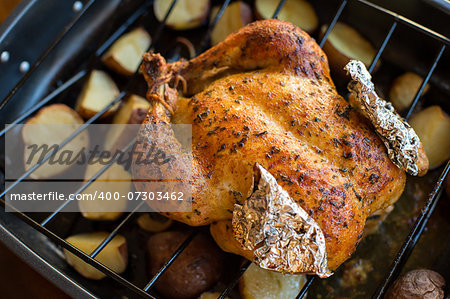 Oven roasted chicken with potatoes just out of the oven.