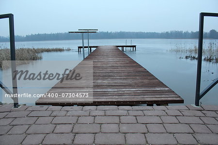 wooden bridge on frozen lake