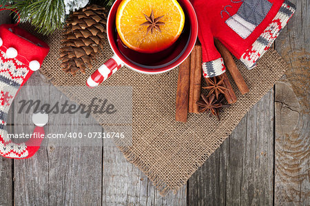 Christmas mulled wine with fir tree and decor on wooden table