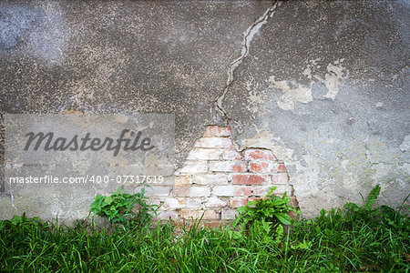 Old broken weathered wall of bricks