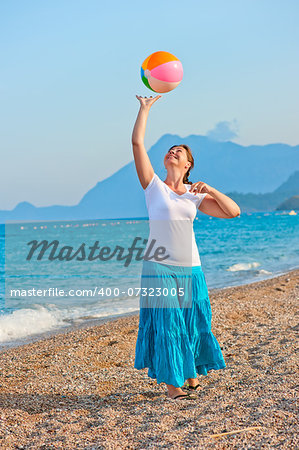 beautiful girl playing on the beach ball