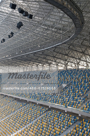 This is an empty stadium seats - Ukraine, Arena Lviv. Seats are painted a yellow and a blue.
