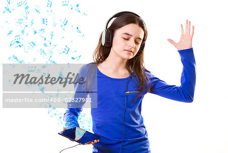 Smiling girl listening to music, holding a tablet pc in hands