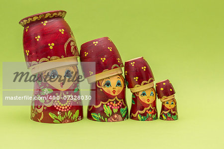 Red russian wooden nesting dolls wearing their bottom as a hat