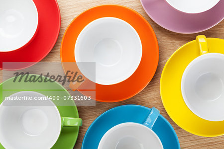 Empty colorful coffee cups on wooden table