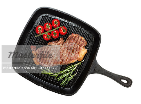 Sirloin steak with rosemary and cherry tomatoes cooking in a frying pan. Isolated on white background. View from above