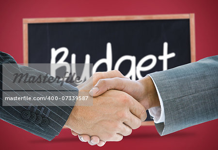 Composite image of business handshake against budget written on a blackboard