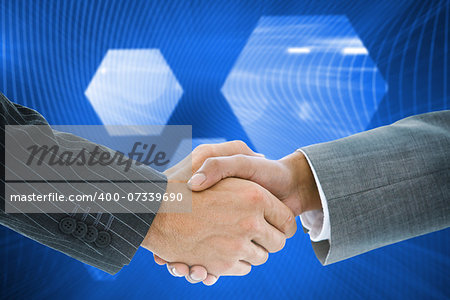 Composite image of business handshake against shiny hexagon on blue background