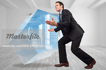 Businessman posing with arms outstretched against digitally generated room with picture frames