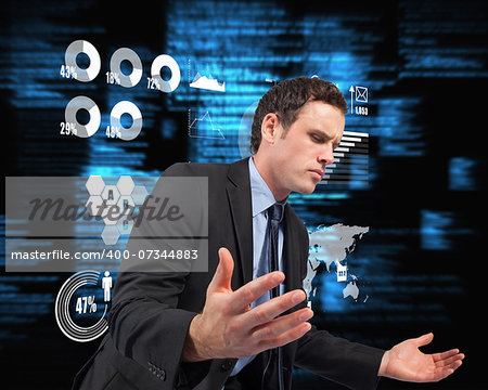 Businessman posing with arms out against blue blurred texts