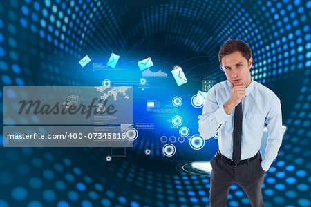 Thoughtful businessman with hand on chin against futuristic dotted blue and black background