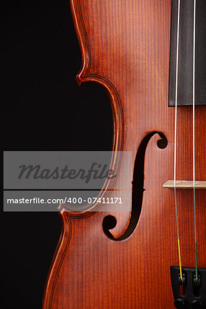 Close up of a violin on black background