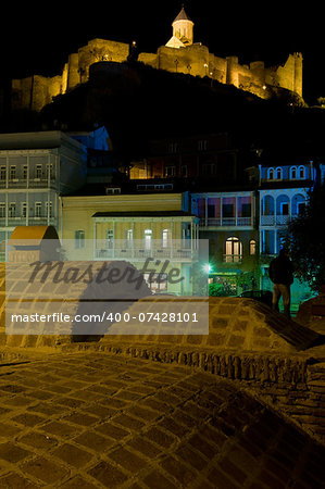 Abanotubani is the ancient district of Tbilisi, Georgia, known for its sulfuric baths. Baths and fortress Naricala are illuminated in night.