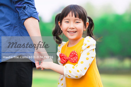 pretty girl hold father hand in the park
