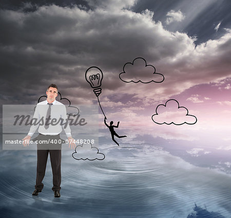 Businessman with empty pockets against light bulb graphic on colourful horizon