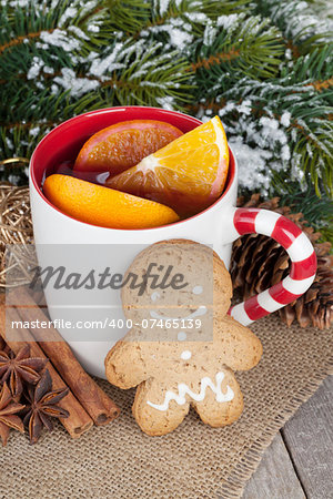Christmas mulled wine with fir tree, gingerbread and spices on wooden table
