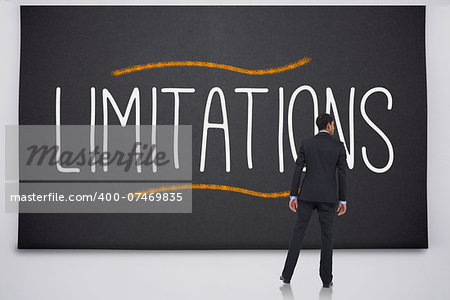 Businessman reading the word limitations