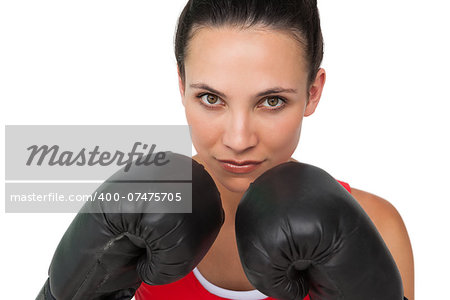 Close-up portrait of a determined female boxer focused on her training over white background