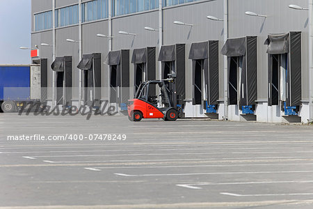 Forklift and loading ramps at distribution warehouse