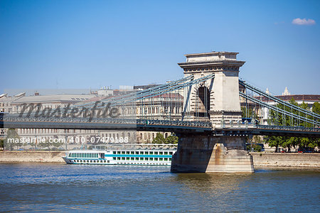 Cruise ships on Danube river with Chain Bridge in front  and Parliament Building in the background, Budapest.