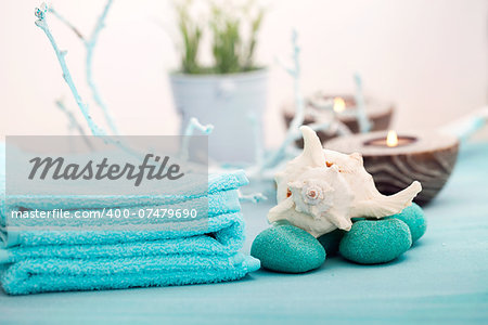 Spa and wellness setting with flowers, candles and towel. Blue dayspa nature set with copyspace