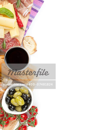 Red wine with cheese, prosciutto, bread, vegetables and spices. Isolated on white background with copy space