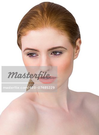 Beautiful redhead posing with hair tied on white background