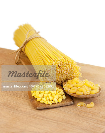 pasta and wooden spoon on a wooden board on a white background