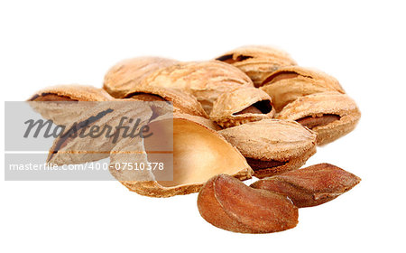 Heap of brown almond nuts isolated on white background. Close-up. Studio photography.