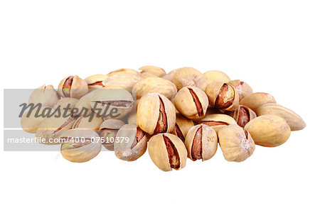 Heap of beige pistachio nuts isolated on white background. Close-up. Studio photography.