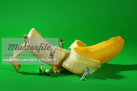 Miniature Construction Workers in Conceptual Food Imagery With Banana