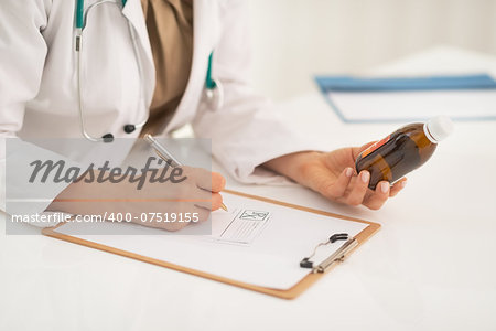 Closeup on medical doctor woman writing prescription
