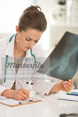 Medical doctor woman with fluorography working in office