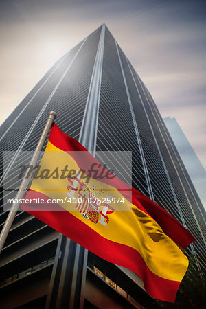 Spain national flag against low angle view of skyscraper