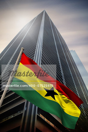 Ghana national flag against low angle view of skyscraper
