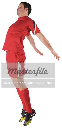 Football player in red jumping on white background