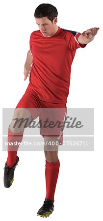 Football player in red kicking on white background
