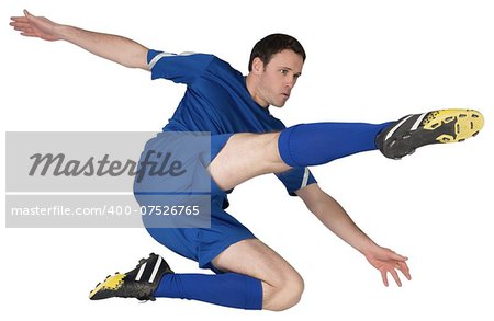 Football player in blue kicking on white background