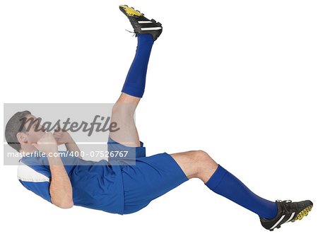 Football player in blue kicking on white background