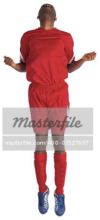 Football player in red jumping on white background