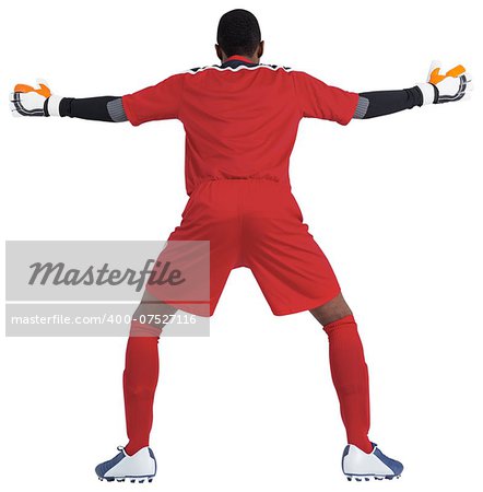 Goalkeeper in red ready to save on white background