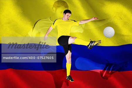 Football player in yellow kicking against digitally generated colombia national flag