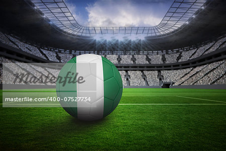Football in nigeria colours in vast football stadium with fans in white