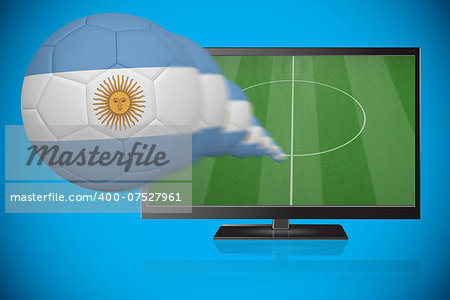 Football in argentina colours flying out of tv against blue background with vignette